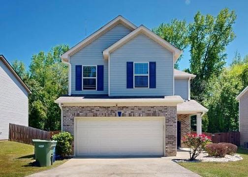 650 Upland Ct, Columbus, GA 31907 - traditional-style home with brick siding, concrete driveway, and a garage