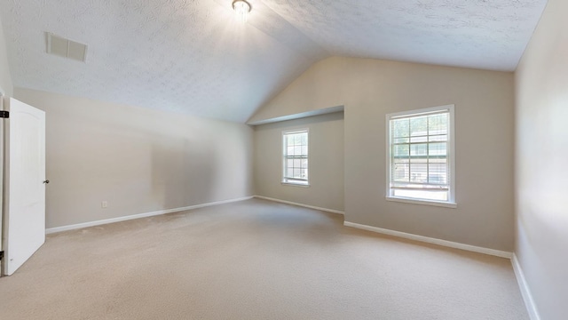 650 Upland Ct, Columbus, GA 31907 - spare room with a textured ceiling, lofted ceiling, carpet flooring, and baseboards
