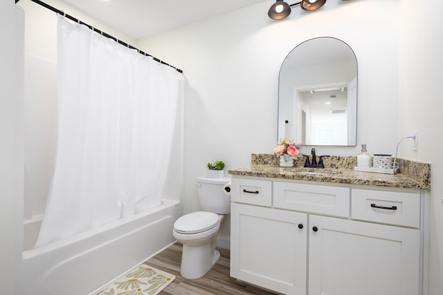 bathroom with shower / bath combo, wood finished floors, toilet, and vanity