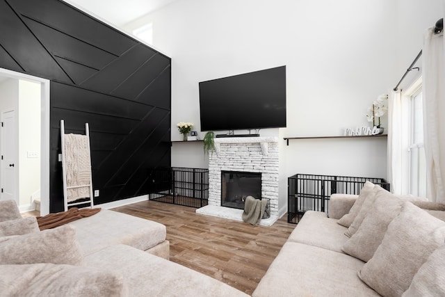 living room with wood finished floors and a fireplace