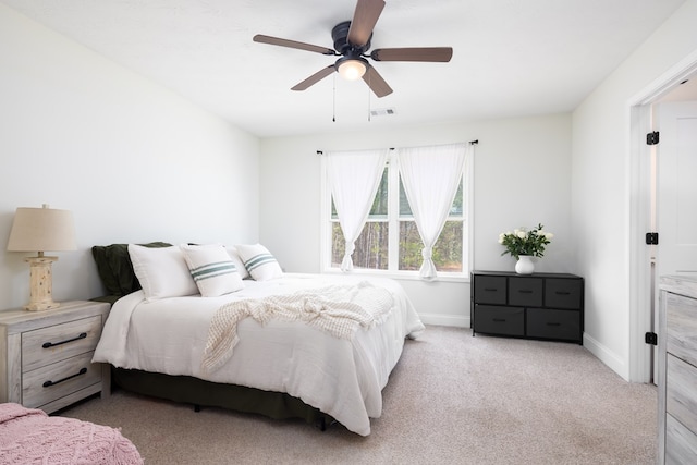 bedroom with baseboards, a ceiling fan, visible vents, and carpet