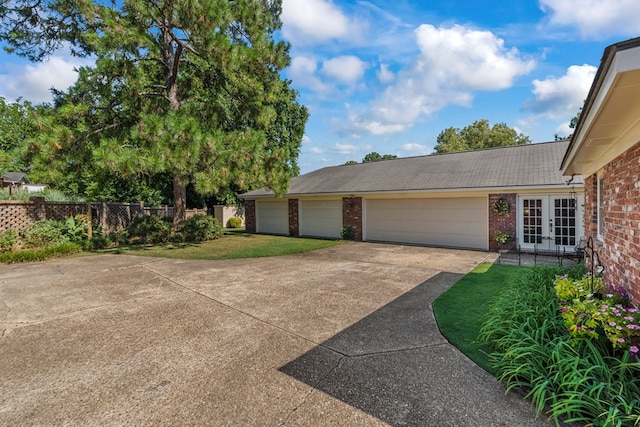 3406 Seminole Dr, Columbus, GA 31907 - view of home's exterior with french doors, concrete driveway, brick siding, and a garage