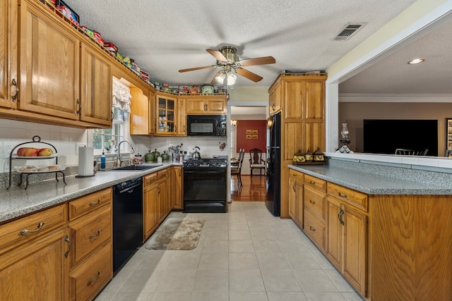 3406 Seminole Dr, Columbus, GA 31907 - kitchen with black appliances, brown cabinets, ceiling fan, glass insert cabinets, and a textured ceiling