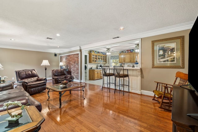 3406 Seminole Dr, Columbus, GA 31907 - living room featuring ornamental molding, ceiling fan, light wood finished floors, a textured ceiling, and recessed lighting