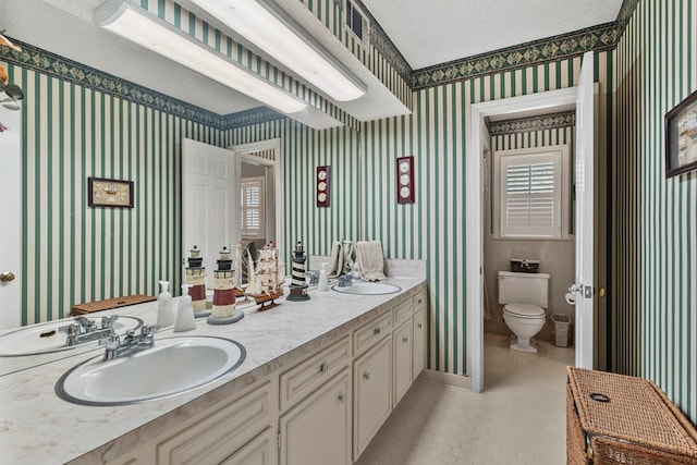 3406 Seminole Dr, Columbus, GA 31907 - bathroom featuring wallpapered walls, double vanity, and a textured ceiling