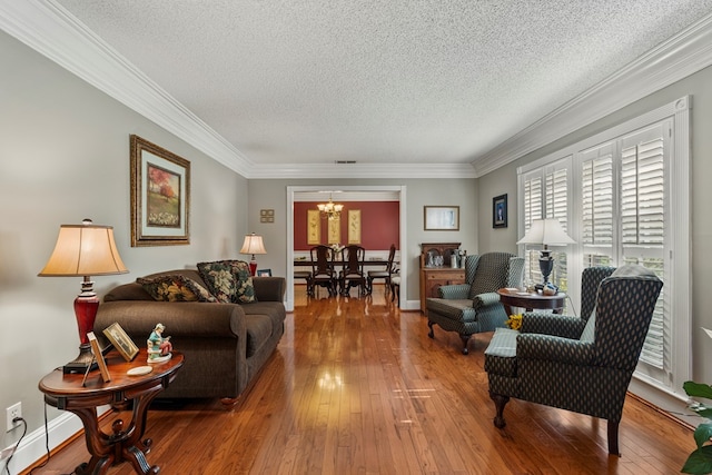 3406 Seminole Dr, Columbus, GA 31907 - living room featuring a chandelier, hardwood / wood-style floors, crown molding, and a textured ceiling