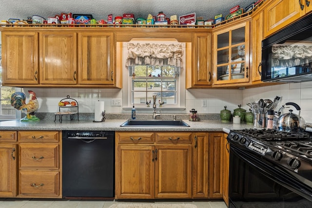 3406 Seminole Dr, Columbus, GA 31907 - kitchen with black appliances, brown cabinets, glass insert cabinets, tasteful backsplash, and light tile patterned floors