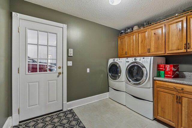 3406 Seminole Dr, Columbus, GA 31907 - laundry room featuring cabinet space, washing machine and clothes dryer, and a textured ceiling