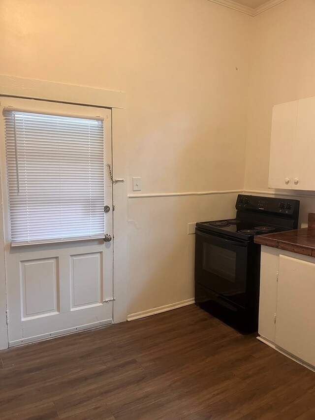 1348 Rhodes St, Columbus, MS 31901 - kitchen featuring black range with electric cooktop, white cabinetry, dark countertops, dark wood-style floors, and crown molding