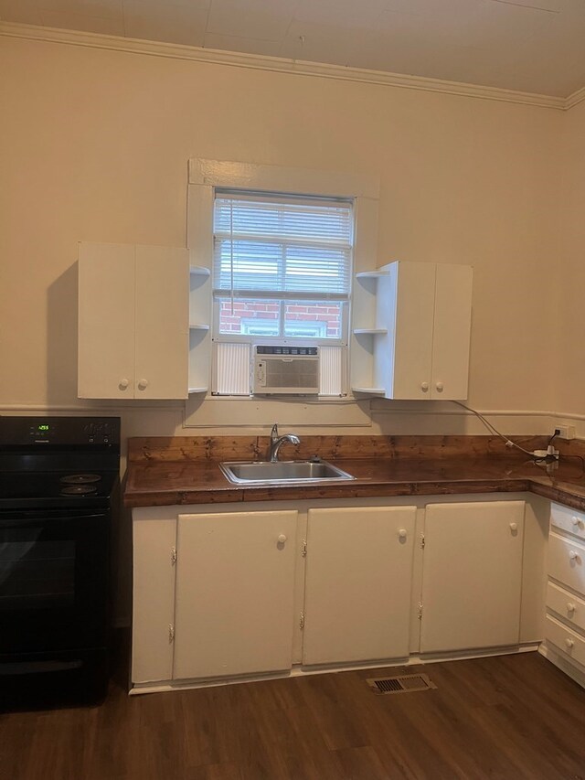 1348 Rhodes St, Columbus, MS 31901 - kitchen with electric stove, open shelves, dark countertops, ornamental molding, and dark wood-style floors