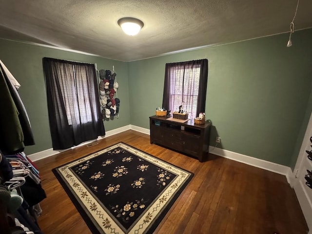 interior space with hardwood / wood-style flooring and a textured ceiling