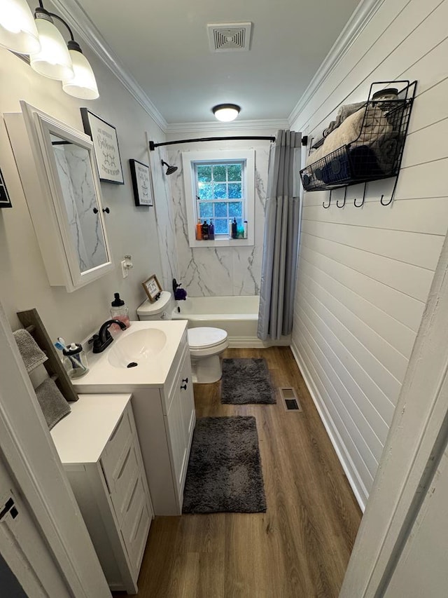 full bathroom featuring toilet, ornamental molding, vanity, shower / bath combo with shower curtain, and hardwood / wood-style floors