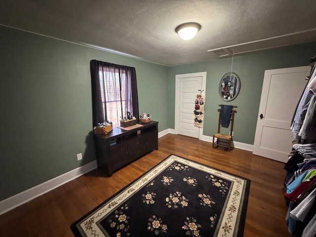 interior space with dark hardwood / wood-style flooring and a textured ceiling