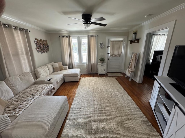 living room with dark wood-type flooring, ornamental molding, and ceiling fan