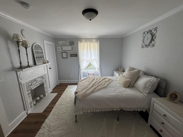 bedroom featuring ornamental molding, dark wood-type flooring, and a fireplace