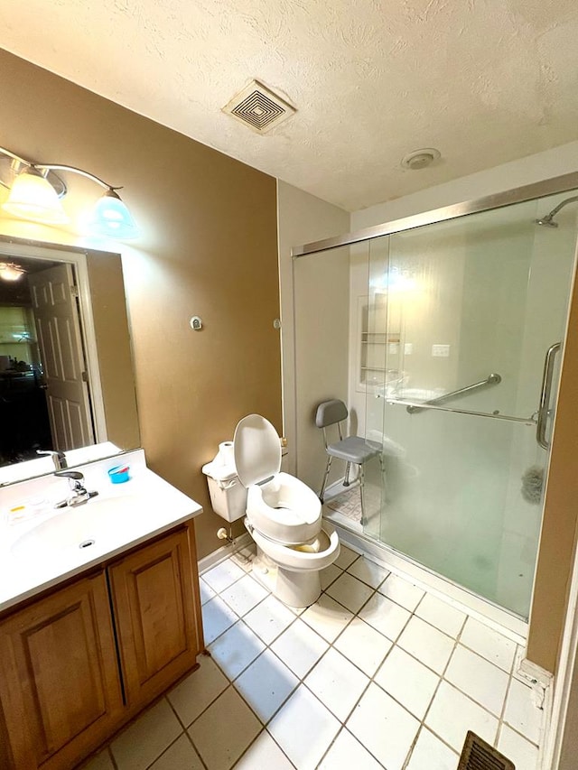 102 Parker St, Lagrange, GA 30240 - bathroom featuring vanity, a stall shower, tile patterned flooring, and a textured ceiling