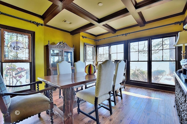 dining area featuring hardwood / wood-style floors, plenty of natural light, and coffered ceiling