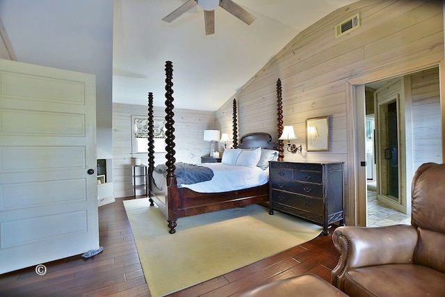 bedroom featuring wooden walls, ceiling fan, high vaulted ceiling, and light wood-type flooring