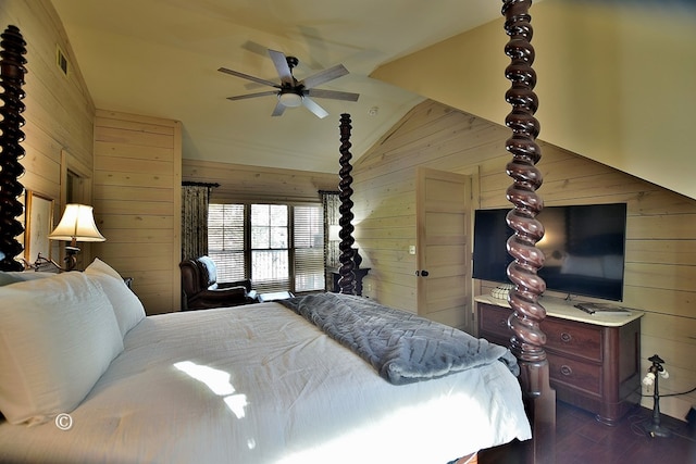 bedroom featuring wood walls, dark hardwood / wood-style flooring, ceiling fan, and lofted ceiling