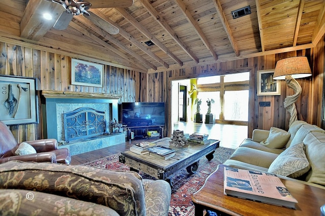 living room with wood ceiling, ceiling fan, wooden walls, beamed ceiling, and hardwood / wood-style floors