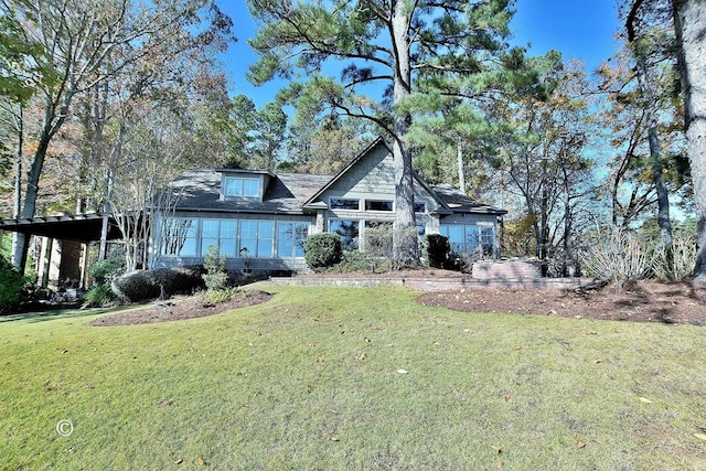 view of front facade with a front yard and a carport