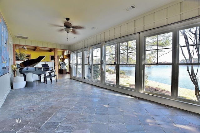 unfurnished sunroom with ceiling fan