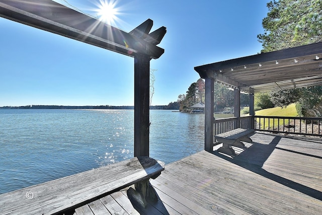 dock area with a pergola and a water view