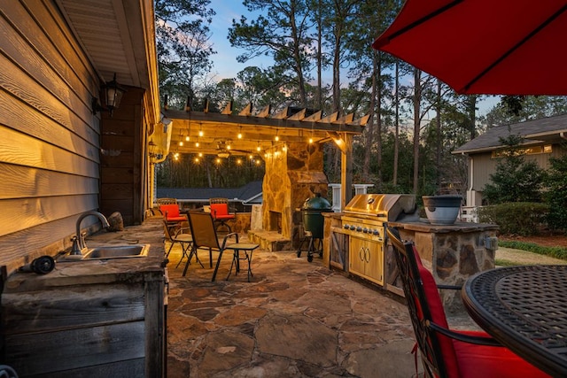 view of patio / terrace featuring outdoor dining area, an outdoor kitchen, a grill, a sink, and a pergola