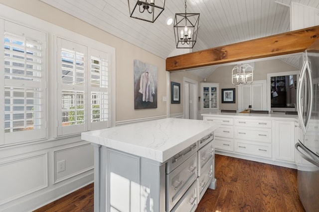 walk in closet with lofted ceiling with beams and dark wood-type flooring