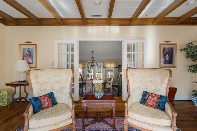 sitting room featuring beamed ceiling, french doors, dark hardwood / wood-style flooring, and a notable chandelier