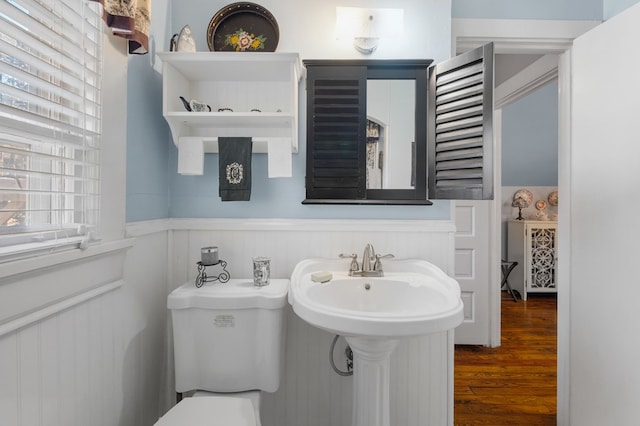 bathroom featuring hardwood / wood-style floors and toilet