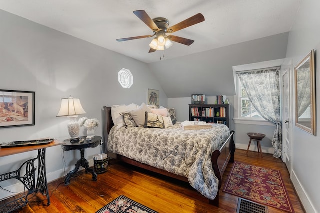 bedroom featuring ceiling fan, hardwood / wood-style floors, and vaulted ceiling