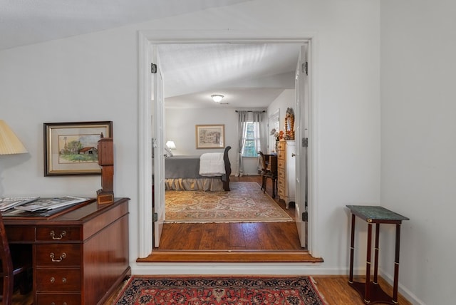 hallway with hardwood / wood-style flooring and a textured ceiling