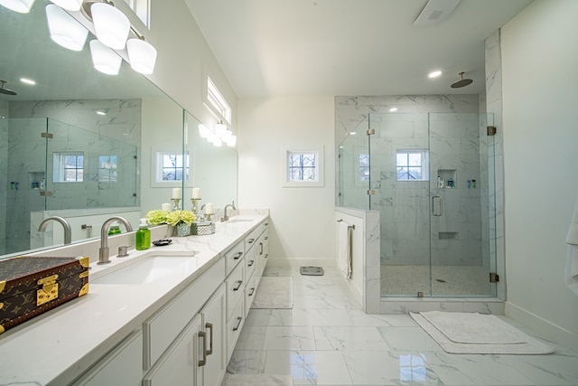 bathroom with a marble finish shower, marble finish floor, a sink, and baseboards