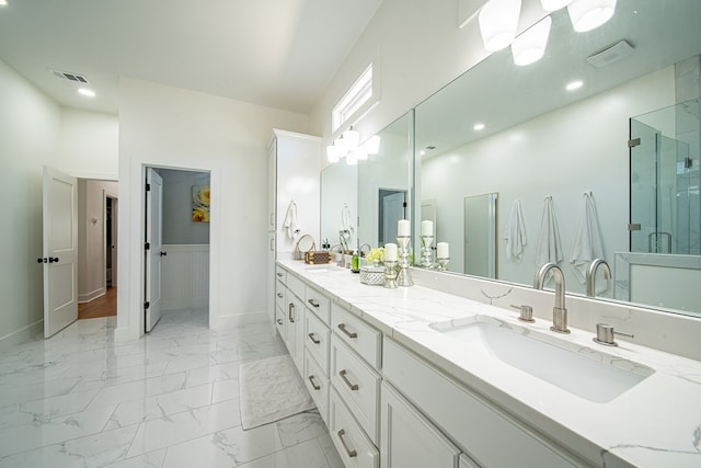 bathroom with marble finish floor, double vanity, visible vents, a sink, and a shower stall