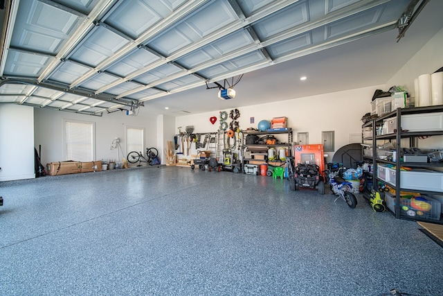 garage featuring a garage door opener and electric panel