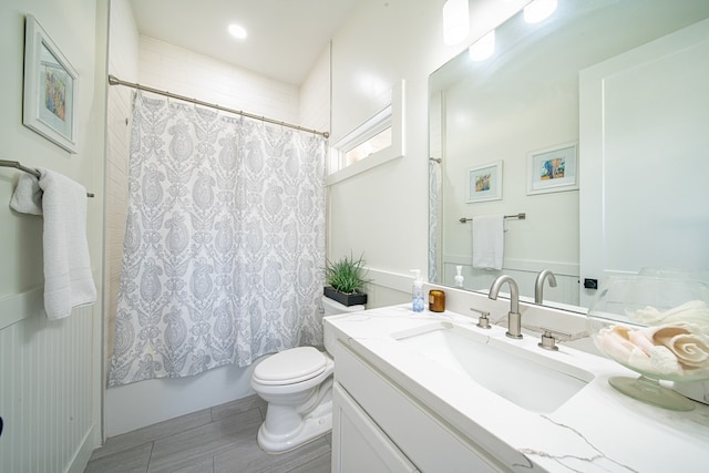 bathroom featuring vanity, toilet, and shower / bathtub combination with curtain