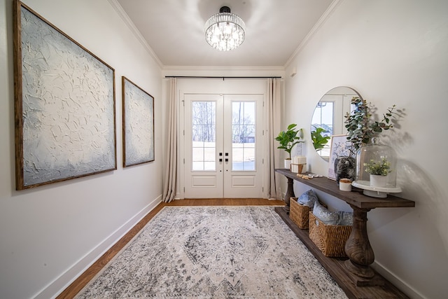 doorway to outside with ornamental molding, french doors, baseboards, and wood finished floors