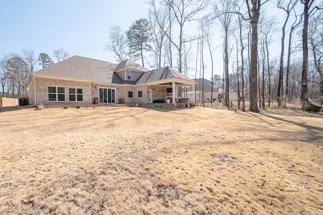 rear view of house with brick siding and central air condition unit