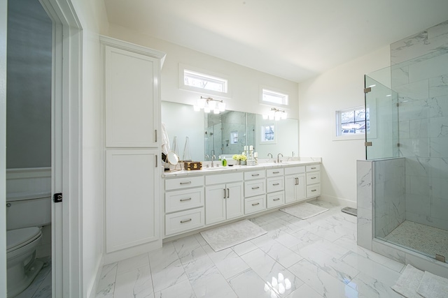 full bathroom with marble finish floor, double vanity, a sink, and a marble finish shower