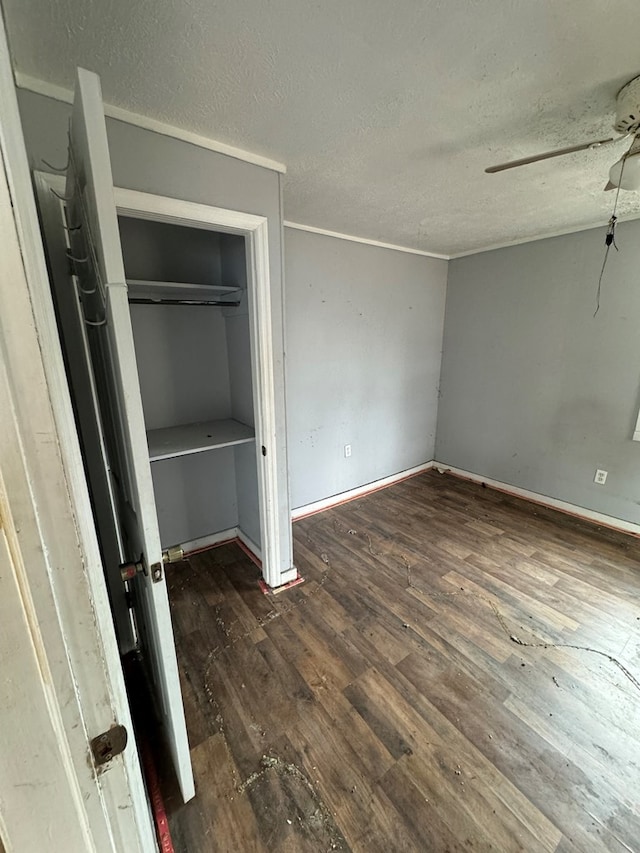 unfurnished bedroom with a ceiling fan, a closet, a textured ceiling, and wood finished floors