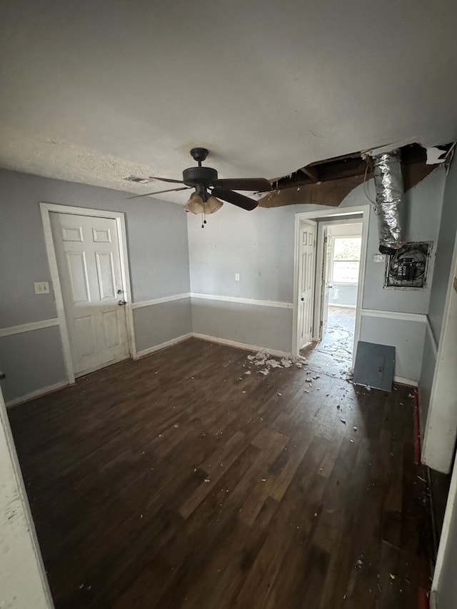 unfurnished living room with wood finished floors, a ceiling fan, and baseboards