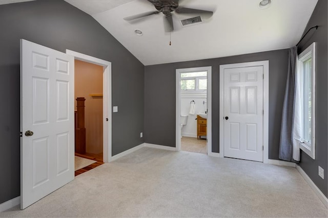 9250-11 River Rd, Fortson, GA 31808 - unfurnished bedroom featuring light colored carpet, vaulted ceiling, connected bathroom, and ceiling fan