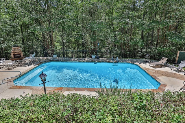 9250-11 River Rd, Fortson, GA 31808 - view of swimming pool with an outdoor stone fireplace and a patio