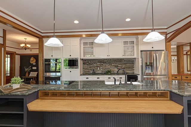 9250-11 River Rd, Fortson, GA 31808 - kitchen featuring appliances with stainless steel finishes, a chandelier, a large island with sink, crown molding, and backsplash