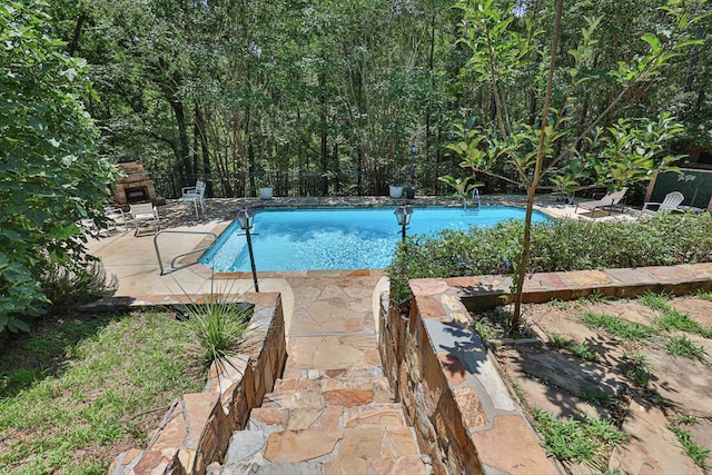 9250-11 River Rd, Fortson, GA 31808 - view of swimming pool featuring an outdoor stone fireplace and a patio area