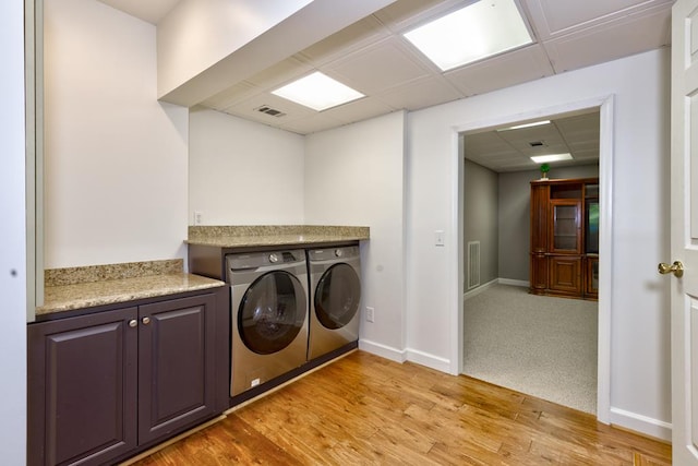 9250-11 River Rd, Fortson, GA 31808 - laundry area with washing machine and dryer, light wood-style floors, and cabinet space