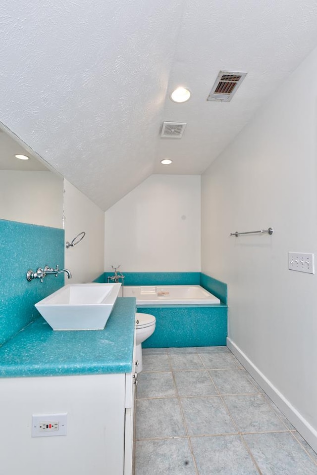 9250-11 River Rd, Fortson, GA 31808 - full bathroom with vanity, vaulted ceiling, recessed lighting, a garden tub, and a textured ceiling