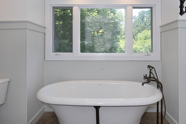 9250-11 River Rd, Fortson, GA 31808 - full bathroom with plenty of natural light, a freestanding tub, and a decorative wall