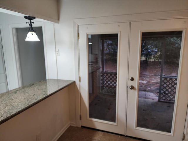 doorway to outside featuring french doors and dark tile patterned floors